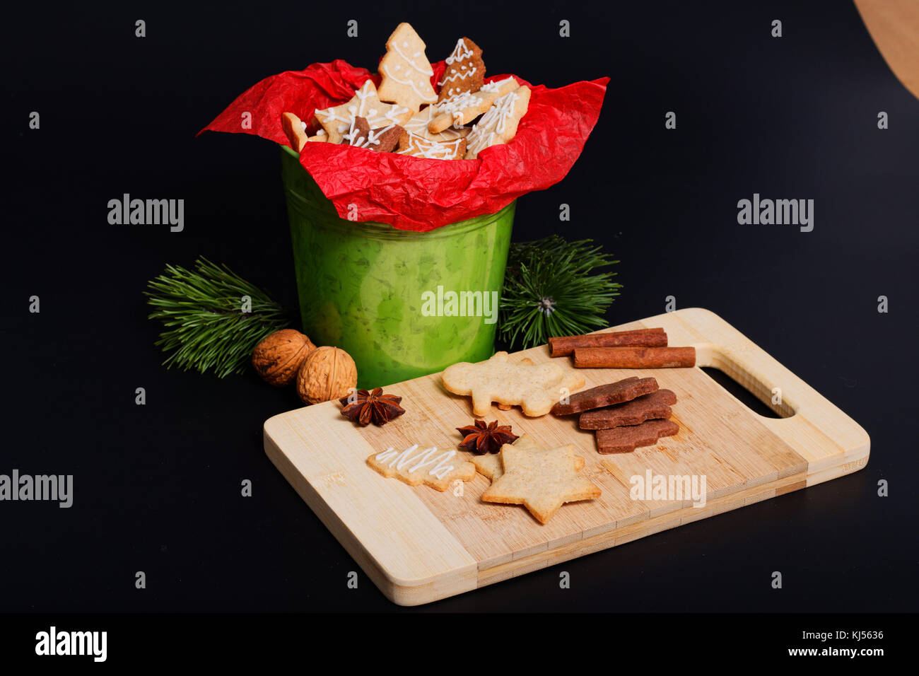 Idea DIY Do it yourself new year and Christmas gift concept butter sugar cookies with royal icing decoration in green bucket with copy space Stock Photo