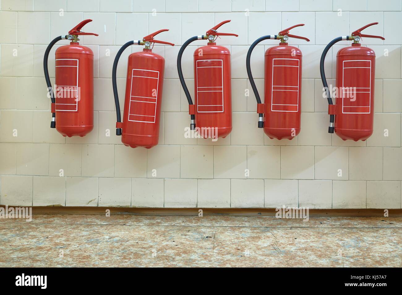 Many fire extinguishers mounted on the wall Stock Photo Alamy