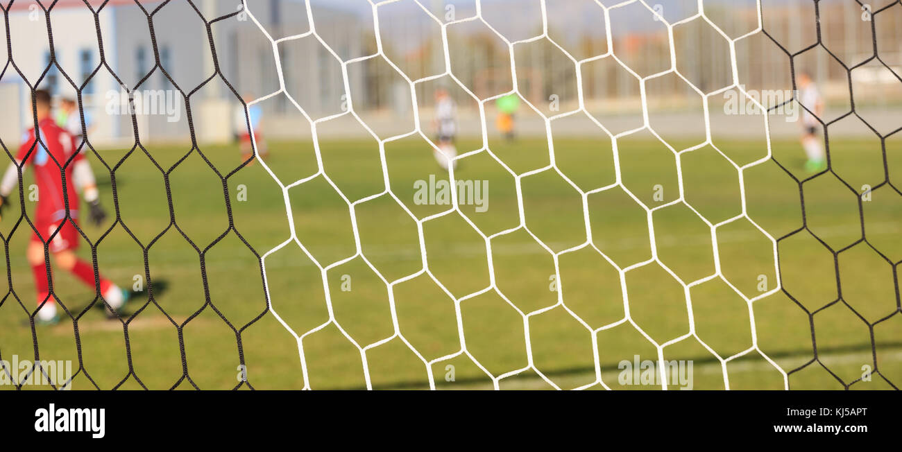 Footballers through goal nets hires stock photography and images Alamy