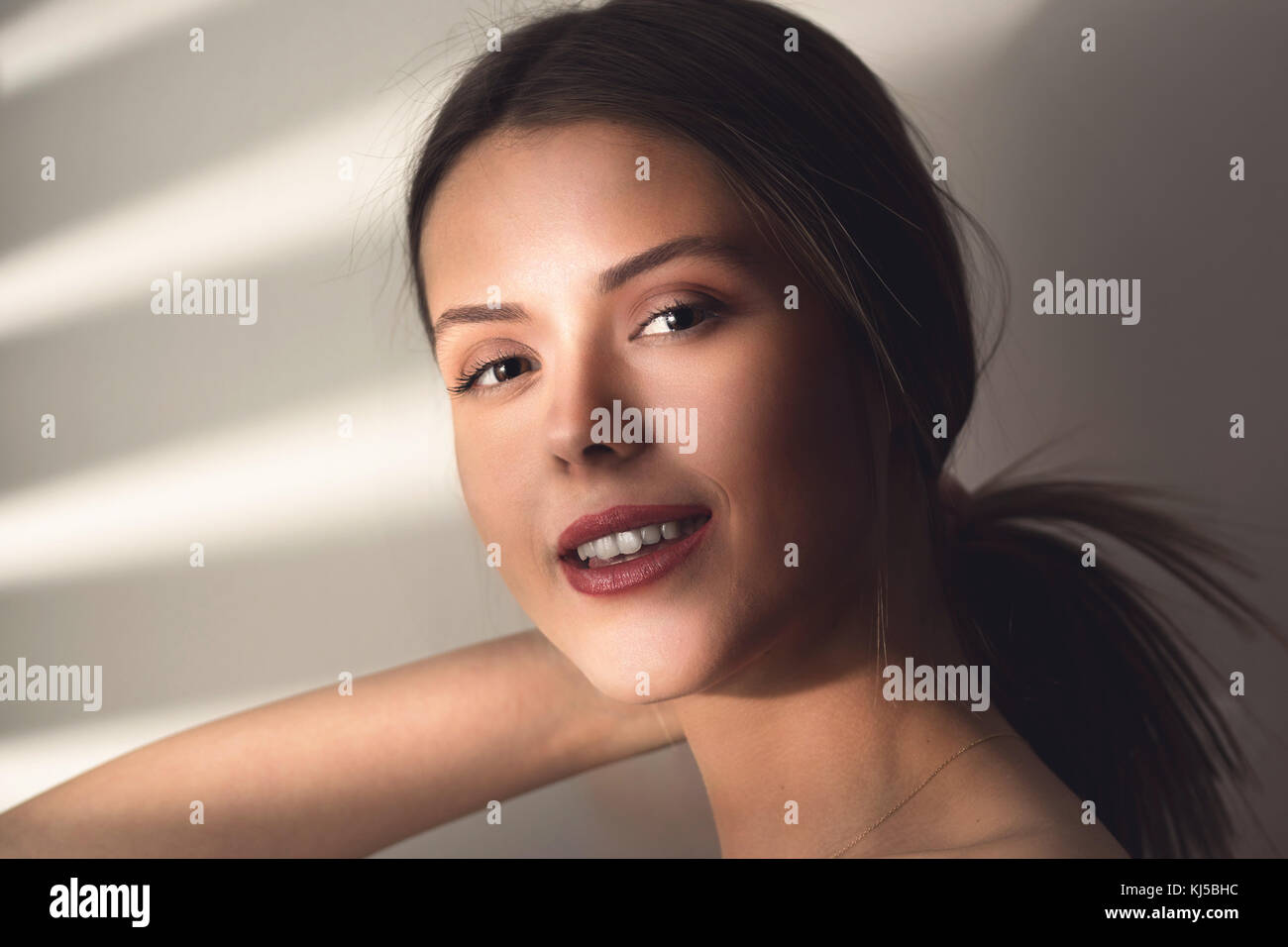 Beautiful young woman face close up portrait. Stock Photo