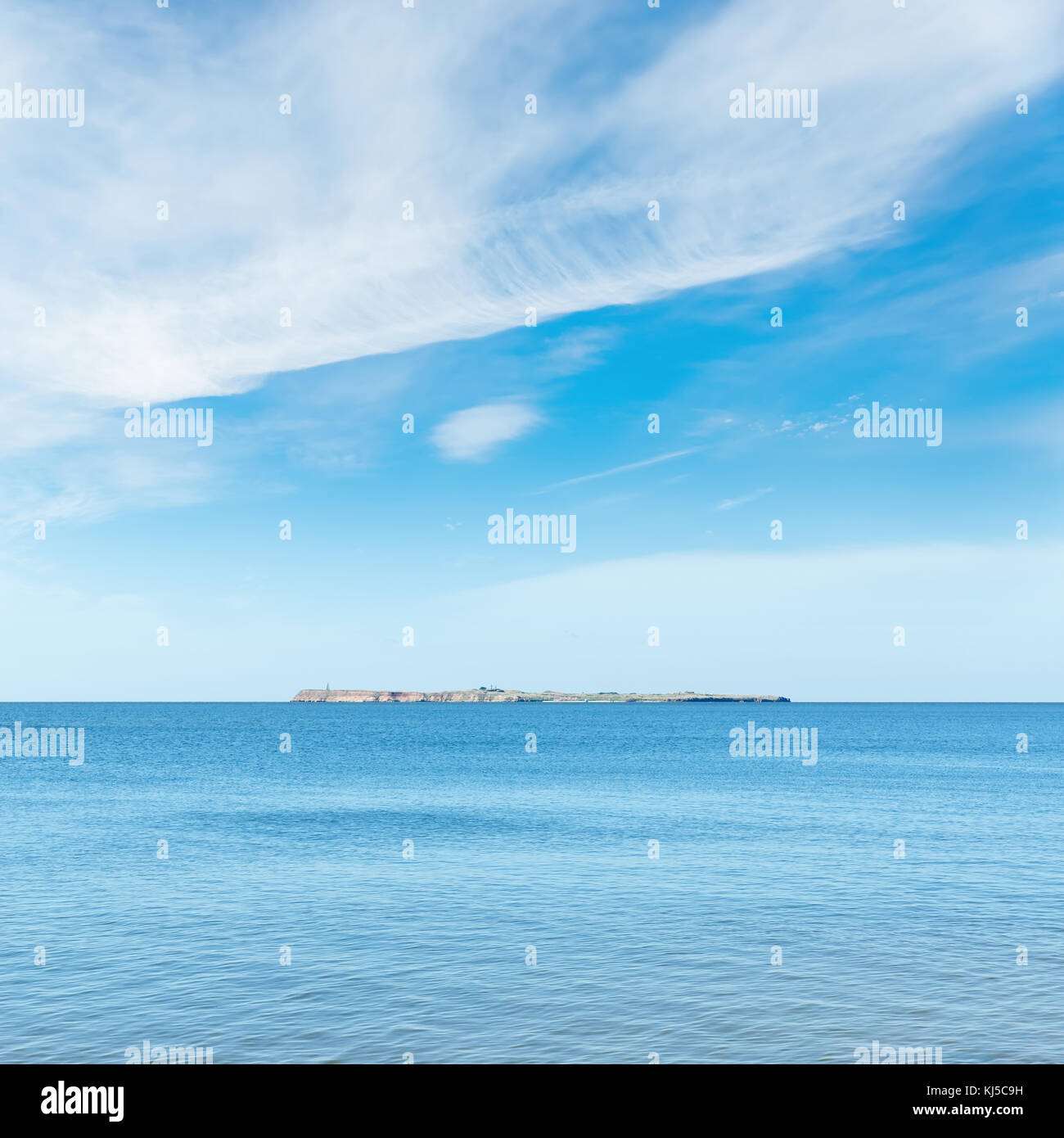 blue sea and sky with clouds. island on horizon Stock Photo - Alamy
