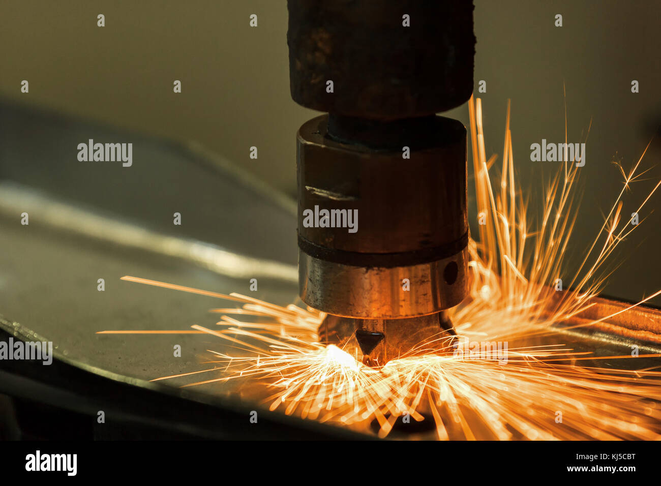 Closeup auto spot welding machine is welding nut to car part Stock