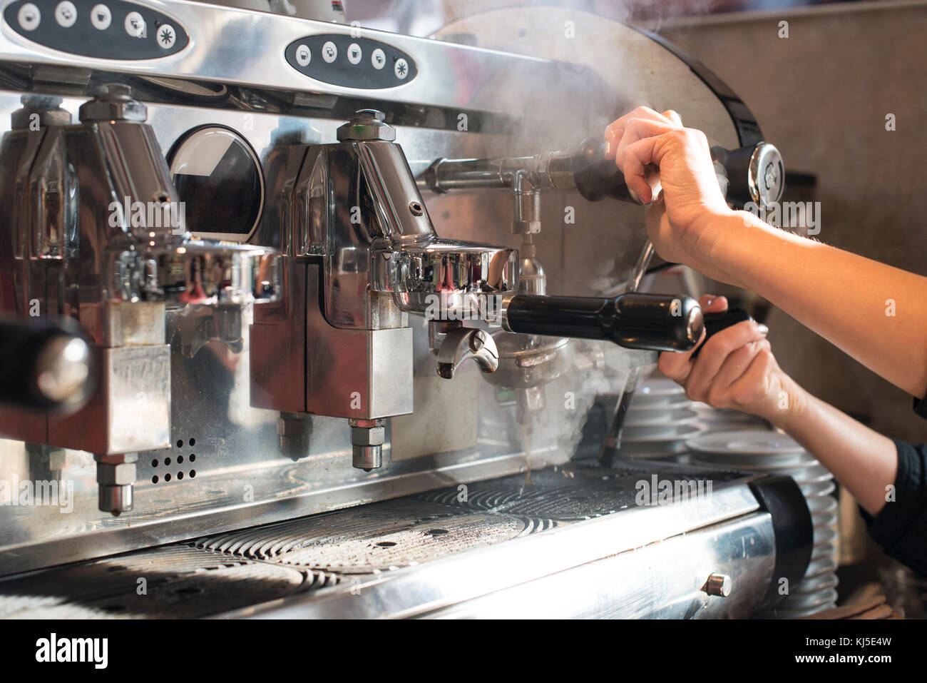 Making coffee on professional coffee machine. Natural light Stock Photo