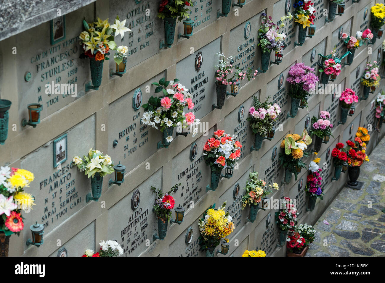 Fresh flowers adorn the burial vaults of the village cemetery, Porto Venere, Italy. Stock Photo