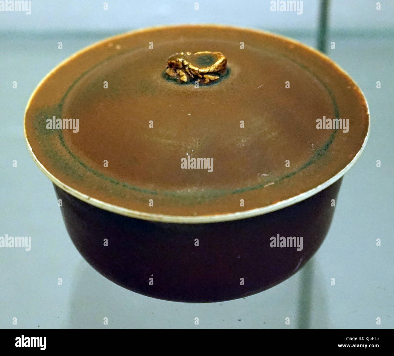 Ding persimmon red glazed covered bowl from the Jin Dynasty. Dated 12th Century Stock Photo