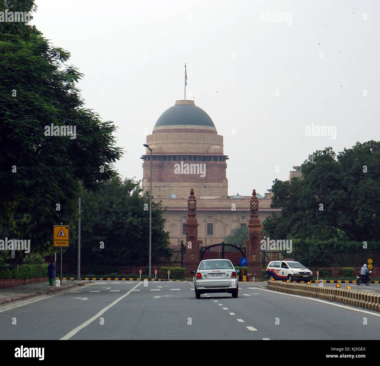 The Rashtrapati Bhavan (Presidential Residence), formerly known as Viceroy's House, is the official home of the President of India, located at the Western end of Rajpath in New Delhi, India. It may refer to only the mansion (the 340-room main building) that has the president's official residence, halls, guest rooms and offices; it may also refer to the entire 130-hectare (320 acre) President Estate that additionally includes huge presidential gardens (Mughal Gardens), Stock Photo