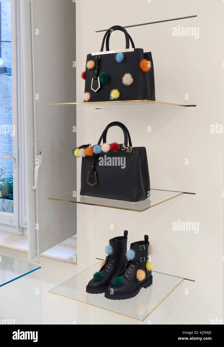 Fendi bags and shoes with pon pon on the shelves of a fashion store Stock Photo