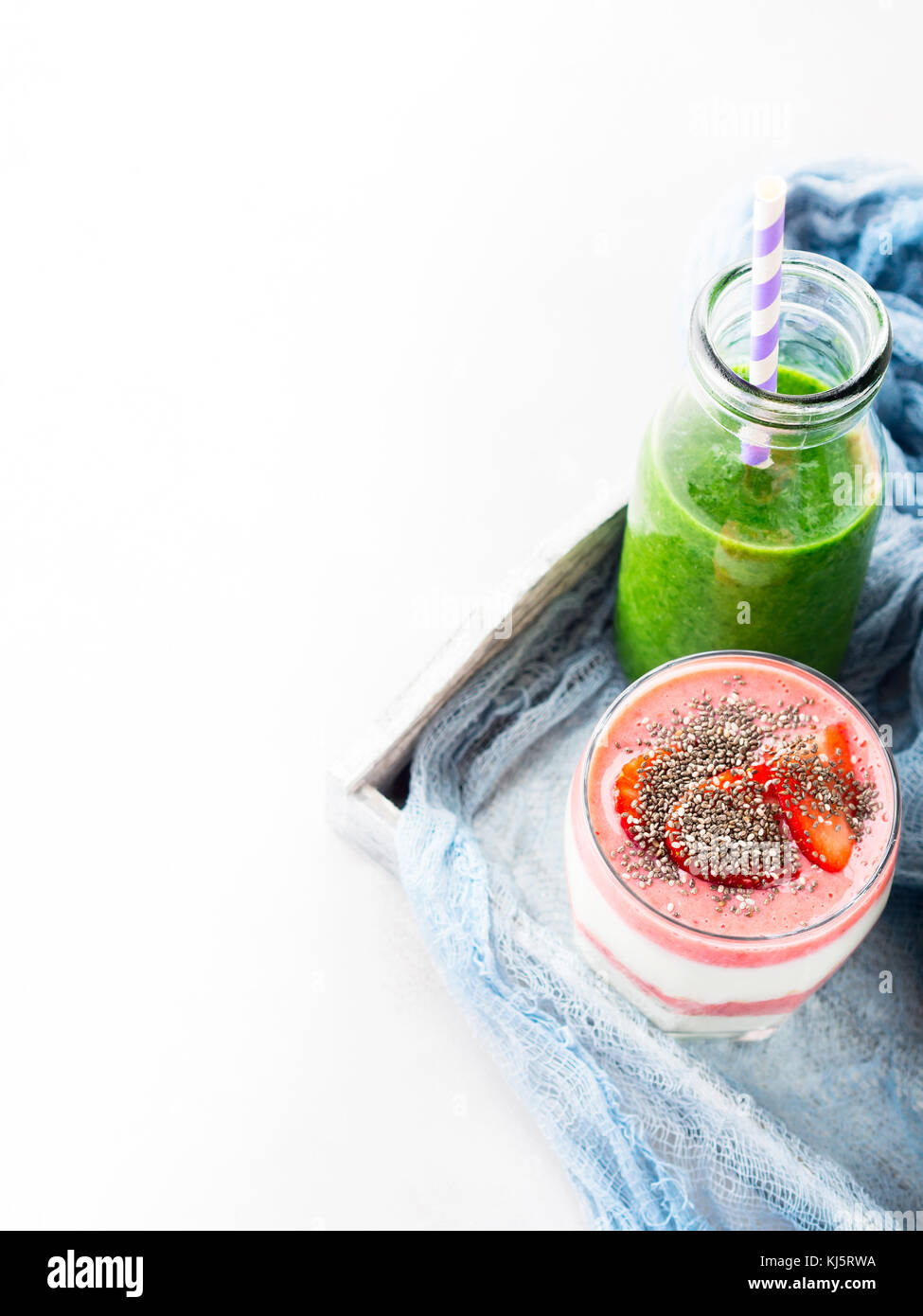 Healthy food concept green smoothie yogurt strawberries chia seeds