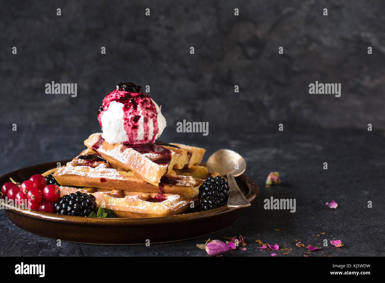 Baked traditional Belgium waffles with ice cream and berry fruit sauce ...