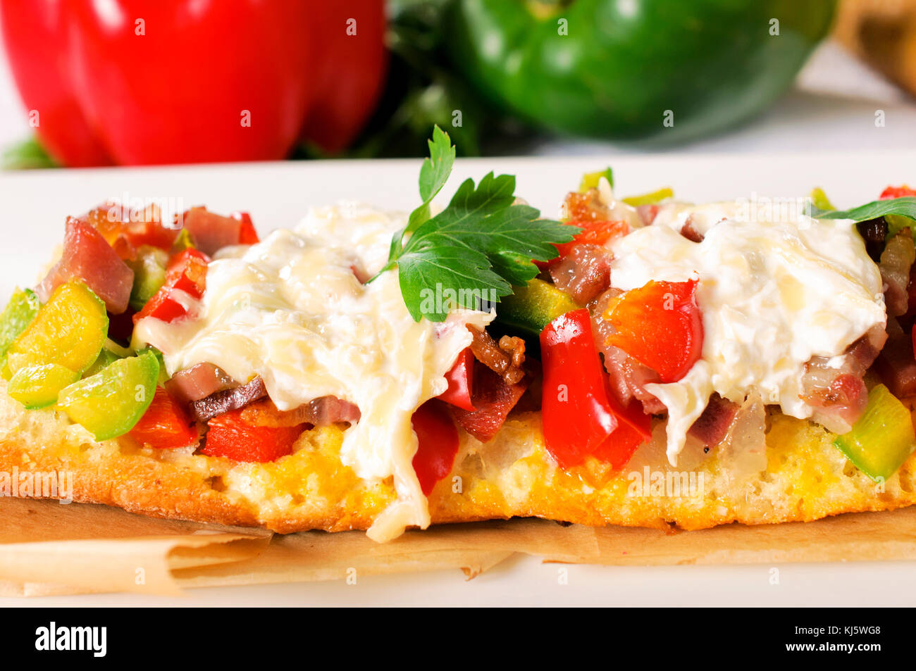 Baguette bread stuffed with meat and peppers.Selective focus in the middle Stock Photo