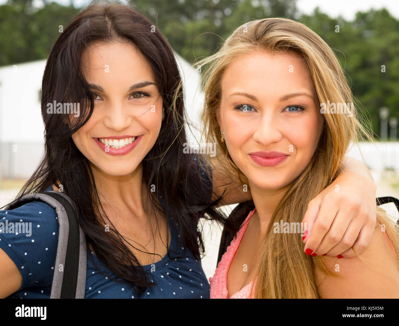Two beautiful and happy teenage students smiling Stock Photo - Alamy