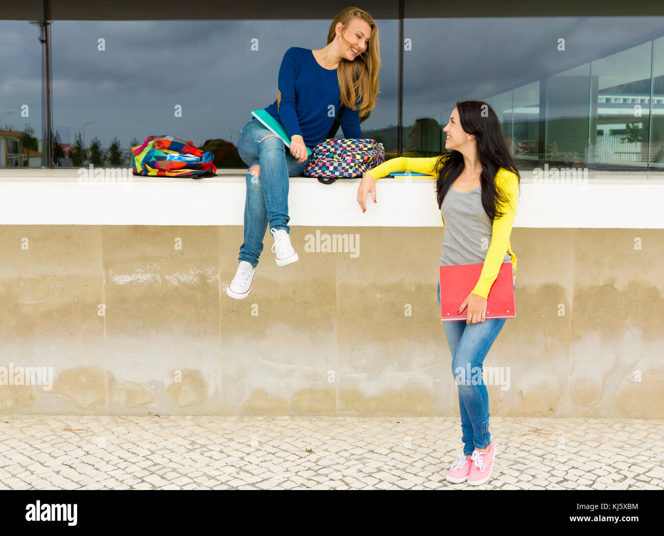 Two happy and beautiful teenage students in the school Stock Photo - Alamy