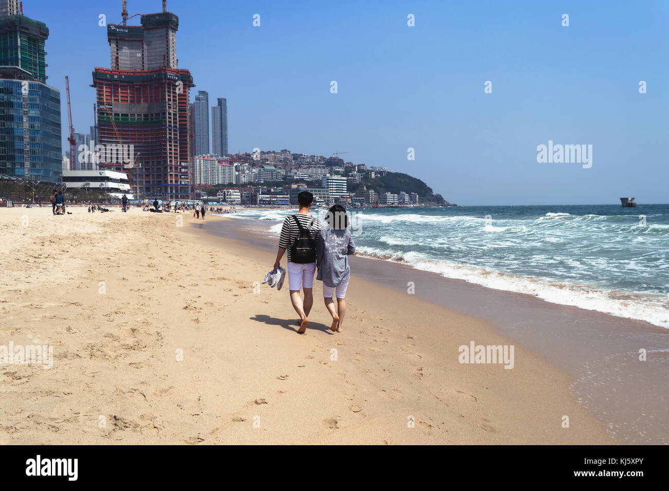 Korean couple walking on Haeundae Beach Stock Photo