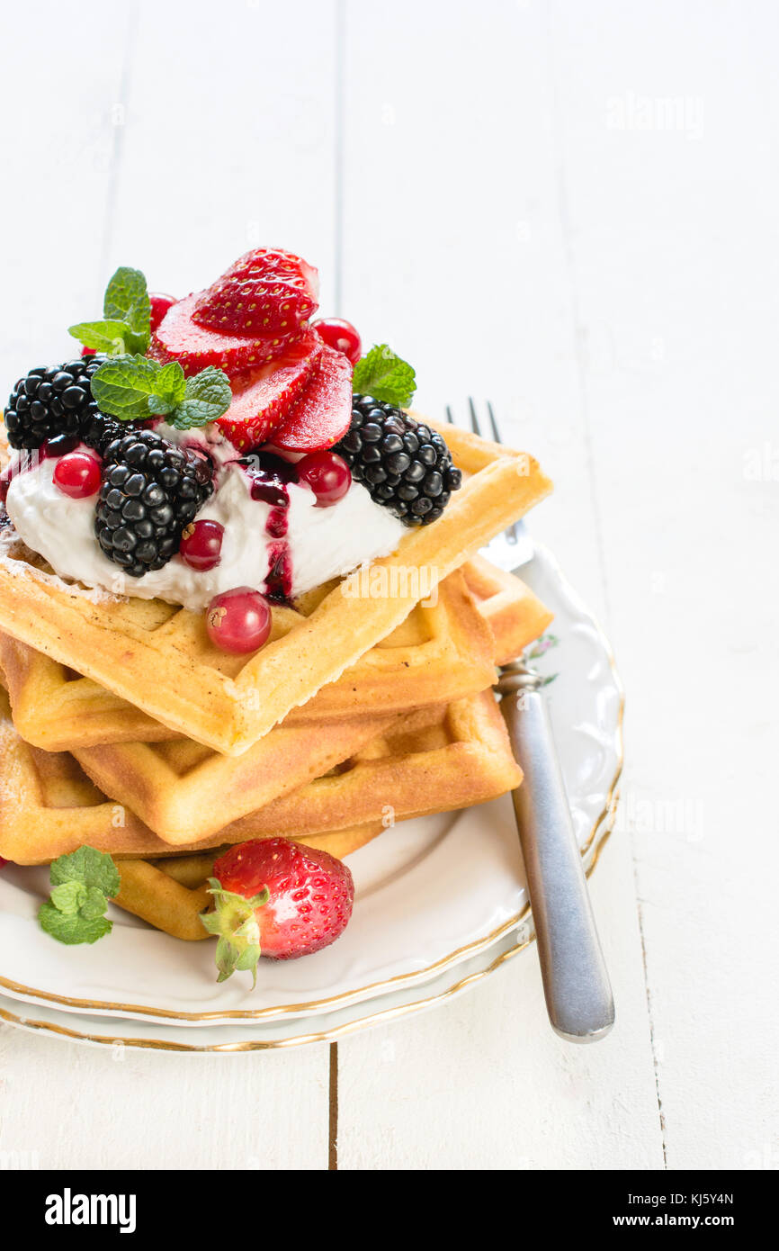 Fresh baked Belgium waffles with berry fruit and vanilla cream ...