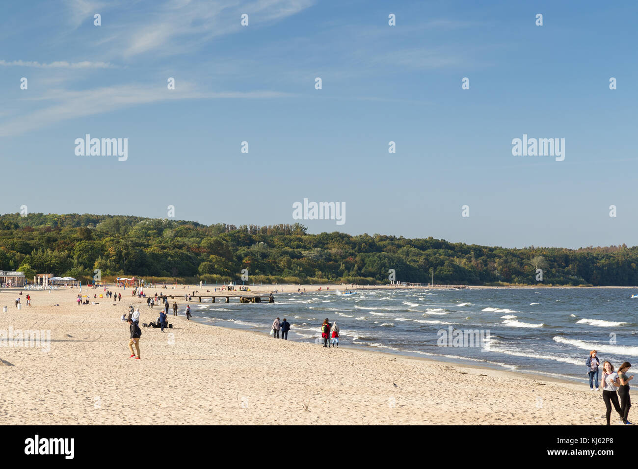 View of the Baltic Sea and people at a beach in Sopot, Poland, on a sunny day in the autumn. Stock Photo