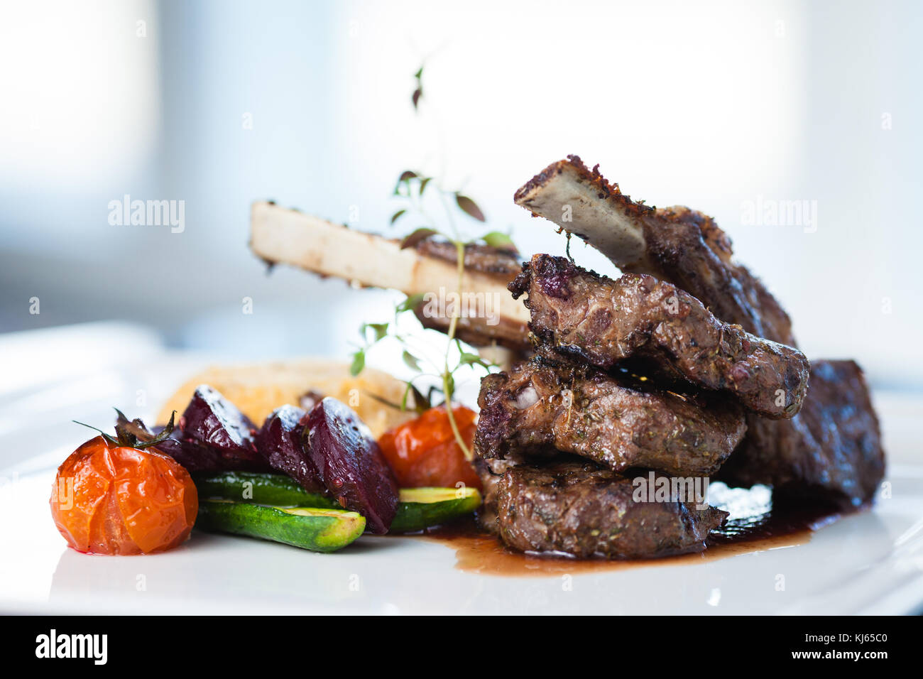 Grilled Lamb Carre With Warm Couscous Salad Roasted Vegetables Dijon Mustard And Red Wine Sauce Stock Photo Alamy