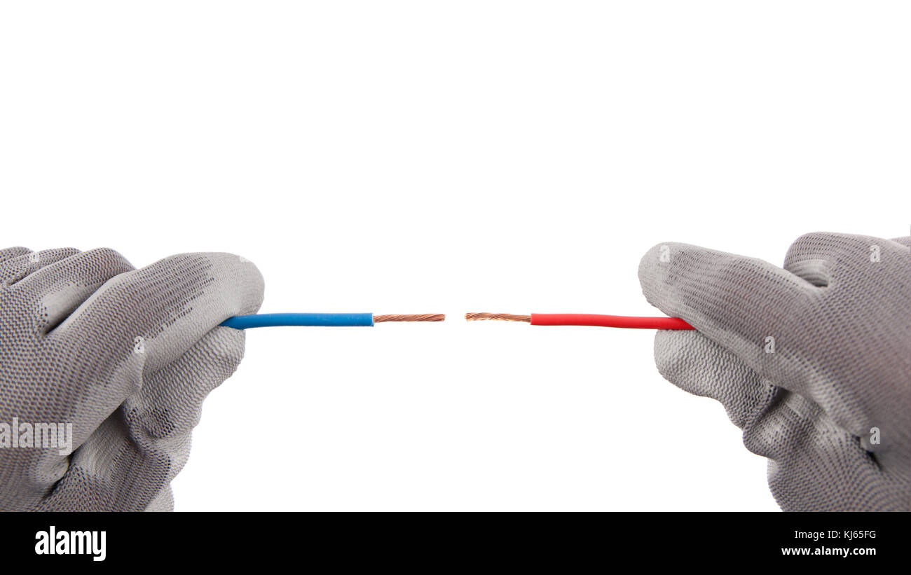 Two wires red and blue against each other in position of short circuit in hands with protective gloves. Stock Photo
