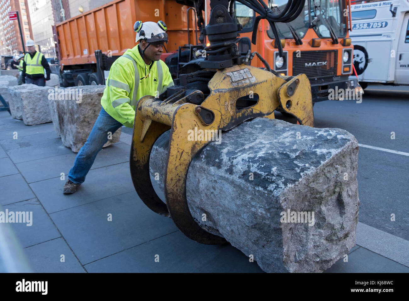 A New York City Parks department worker helps install anti-terror blockades at hte south end of Union Square Park in New York City. Stock Photo