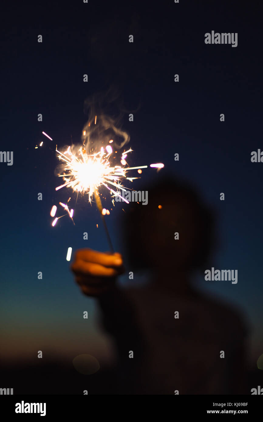 Anonymous person with burning firework Stock Photo - Alamy