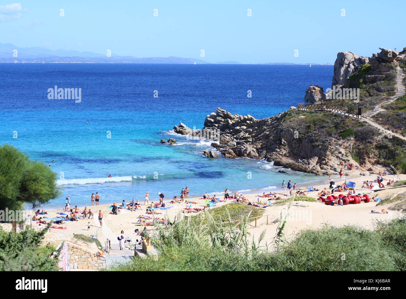 Holiday Tourists Enjoying The Sandy Beach And Relaxing In