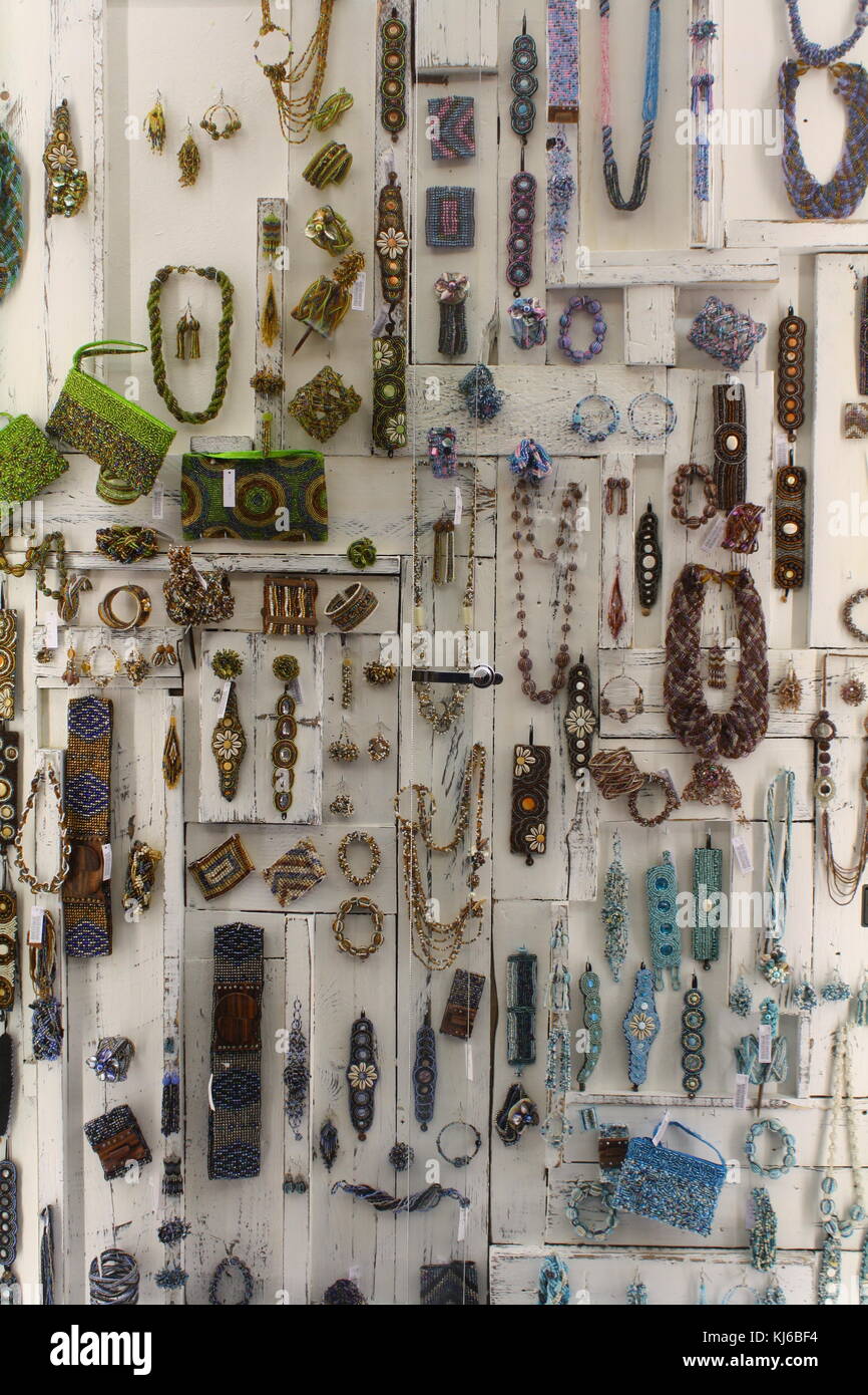Lots of bijou jewellery for sale on display in a storefront Stock Photo