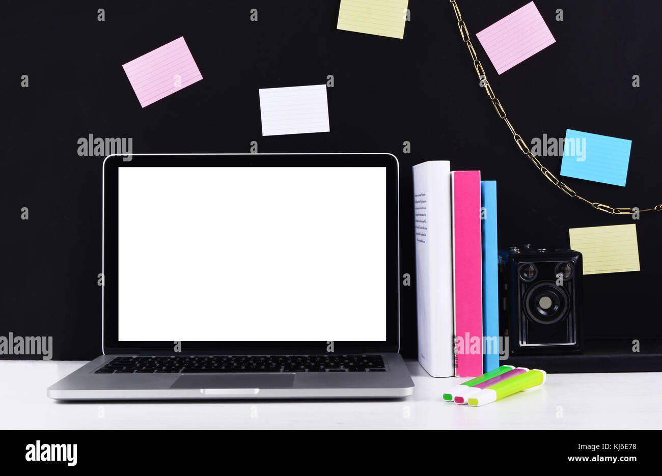 Stylish workspace with laptop computer, office supplies, camera, sticky ...