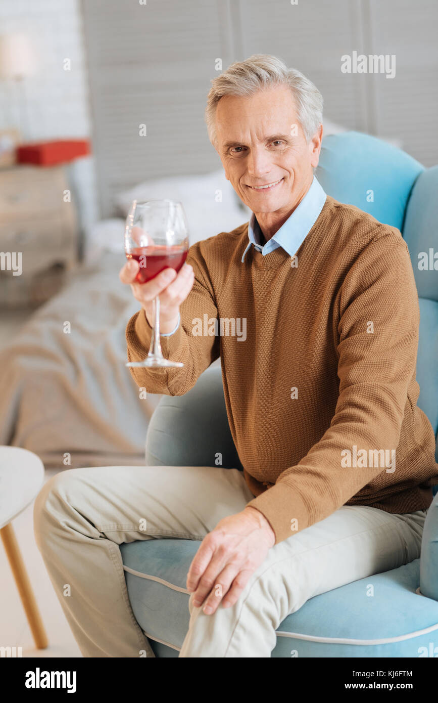 Smiling elderly gentleman drinking red wine at home Stock Photo - Alamy