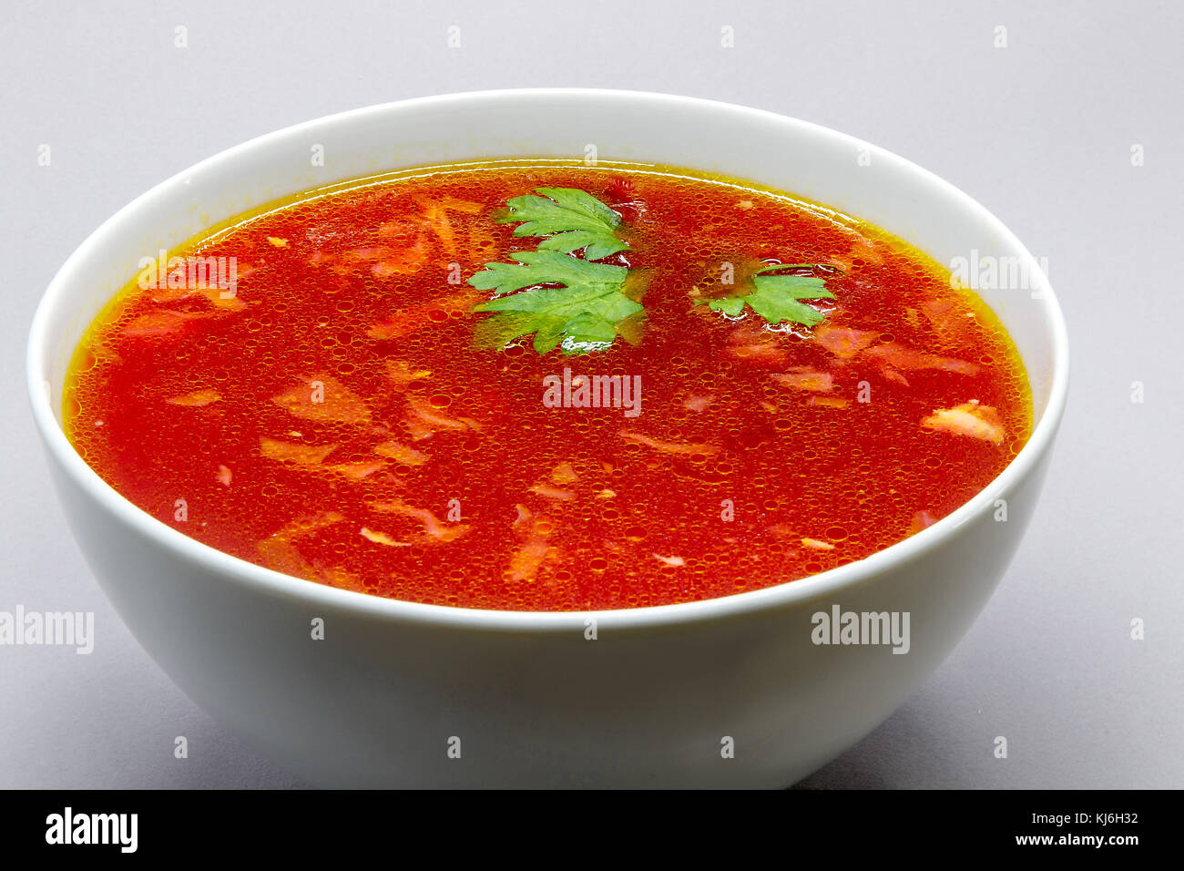 Borscht, Russian beet soup, in a white bowl. Stock Photo