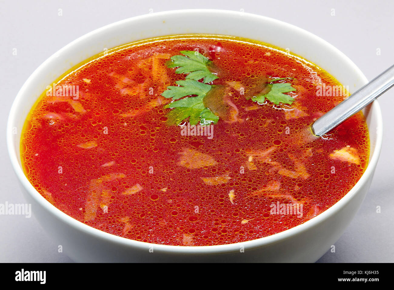 Borscht, Russian beet soup, in a white bowl. Stock Photo