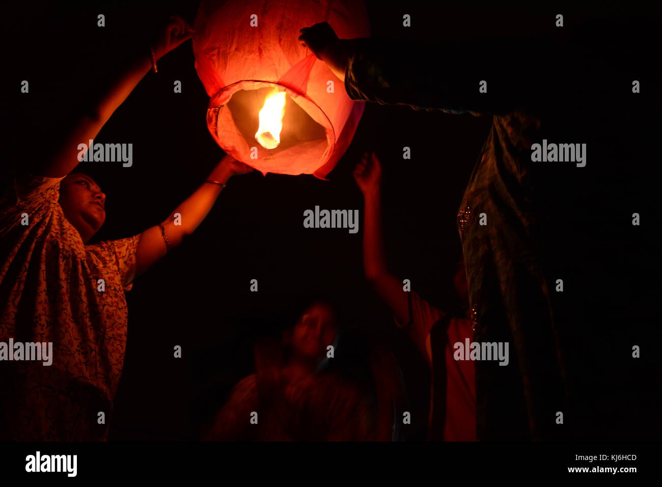 People flying a sky lantern during Diwali the festival of lights, in
