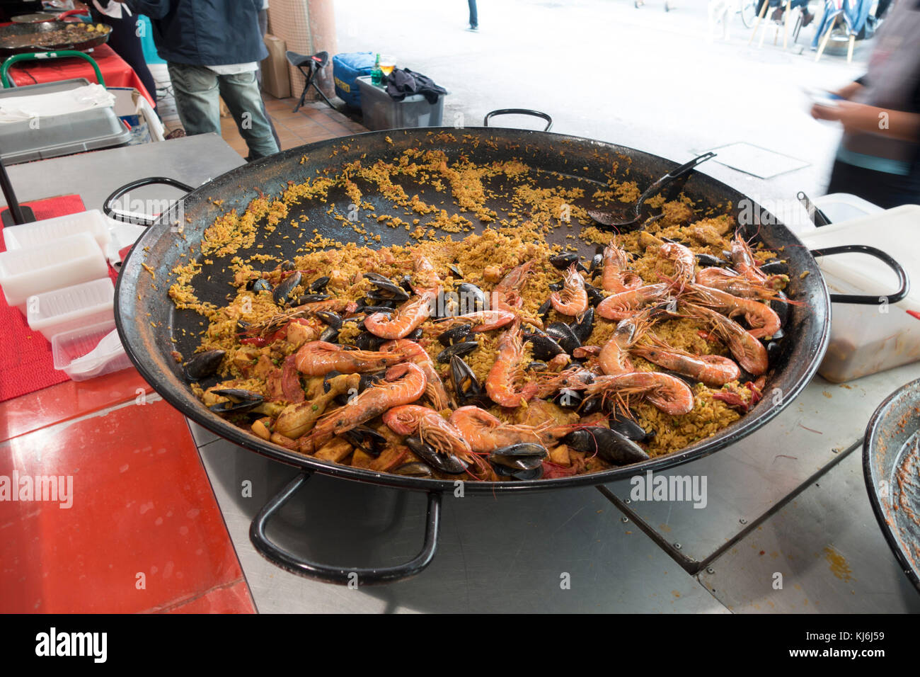 Traditional Paella Pan cooking Paella dish in market. Stock Photo