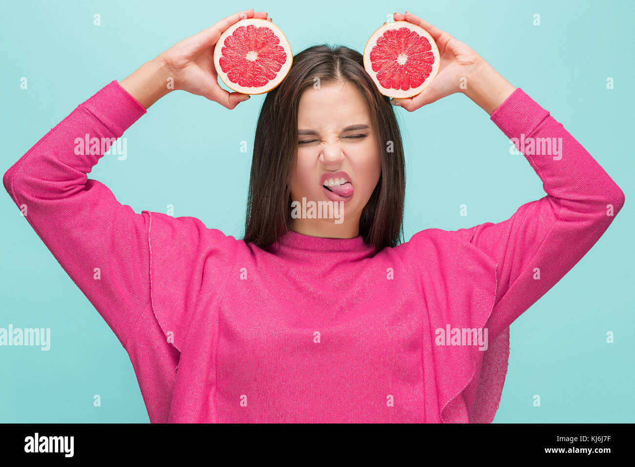 Pretty woman with delicious grapefruit in her arms Stock Photo Alamy