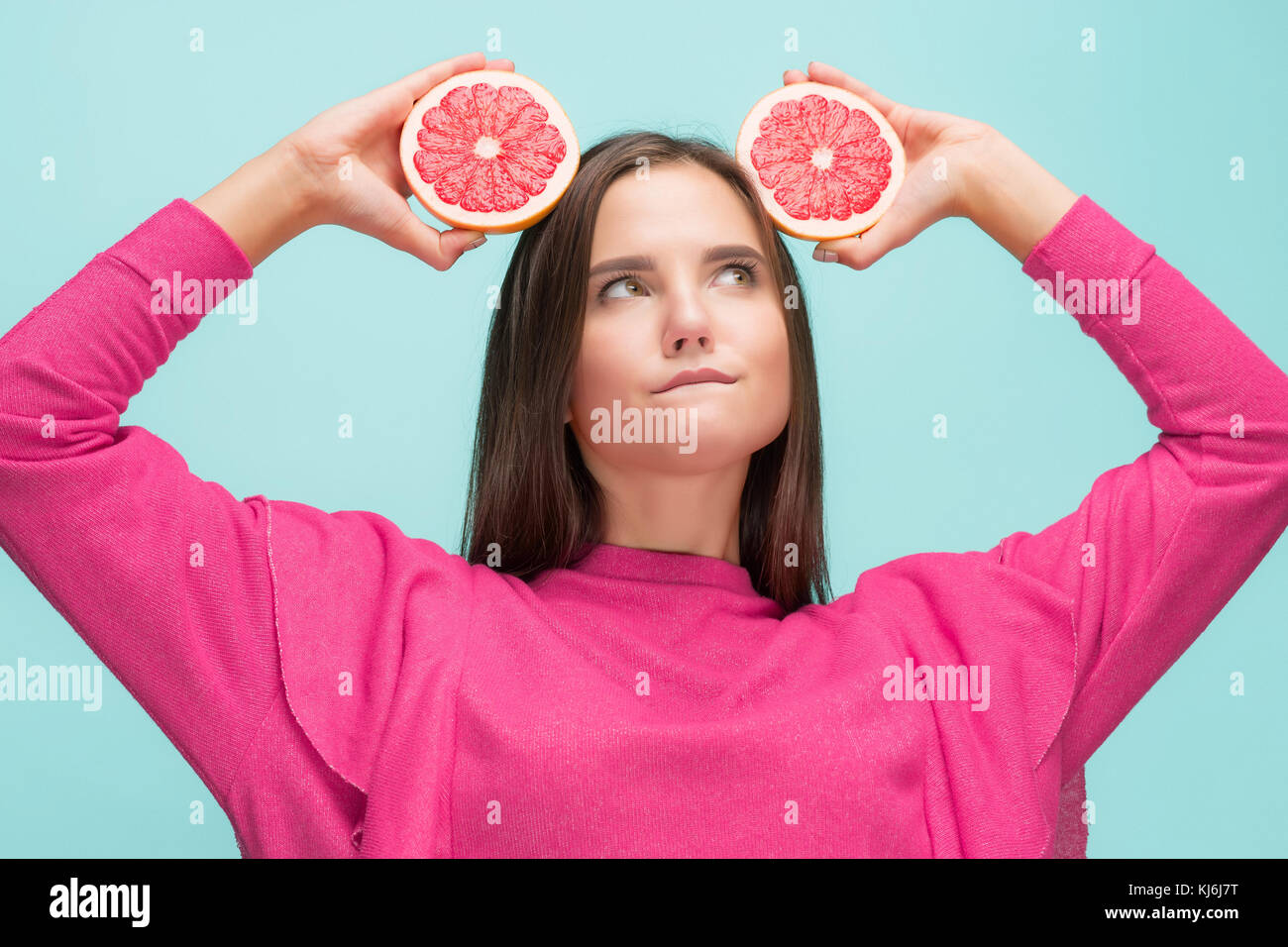 Pretty woman with delicious grapefruit in her arms Stock Photo Alamy