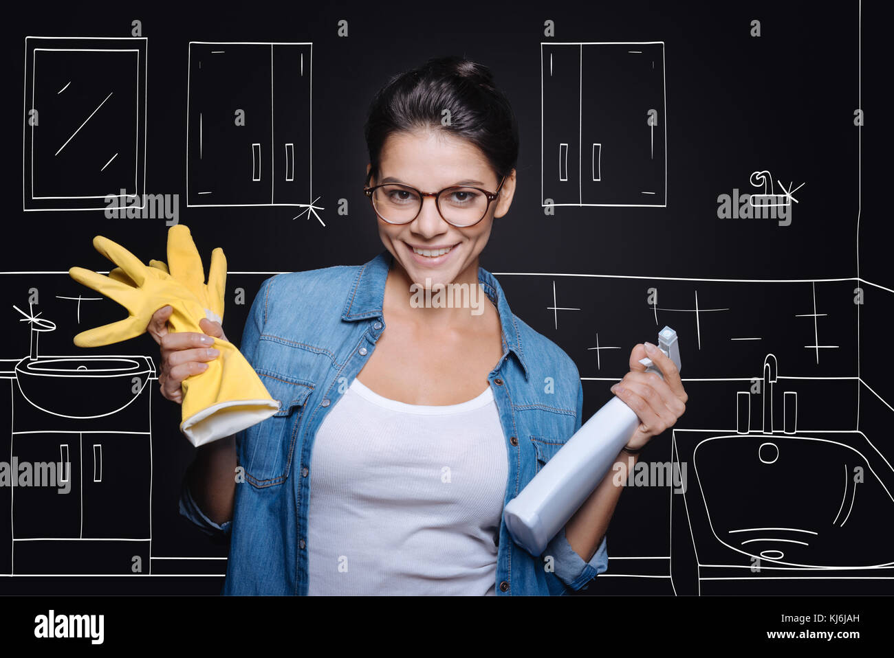 Positive delighted woman being involved in household chores Stock Photo