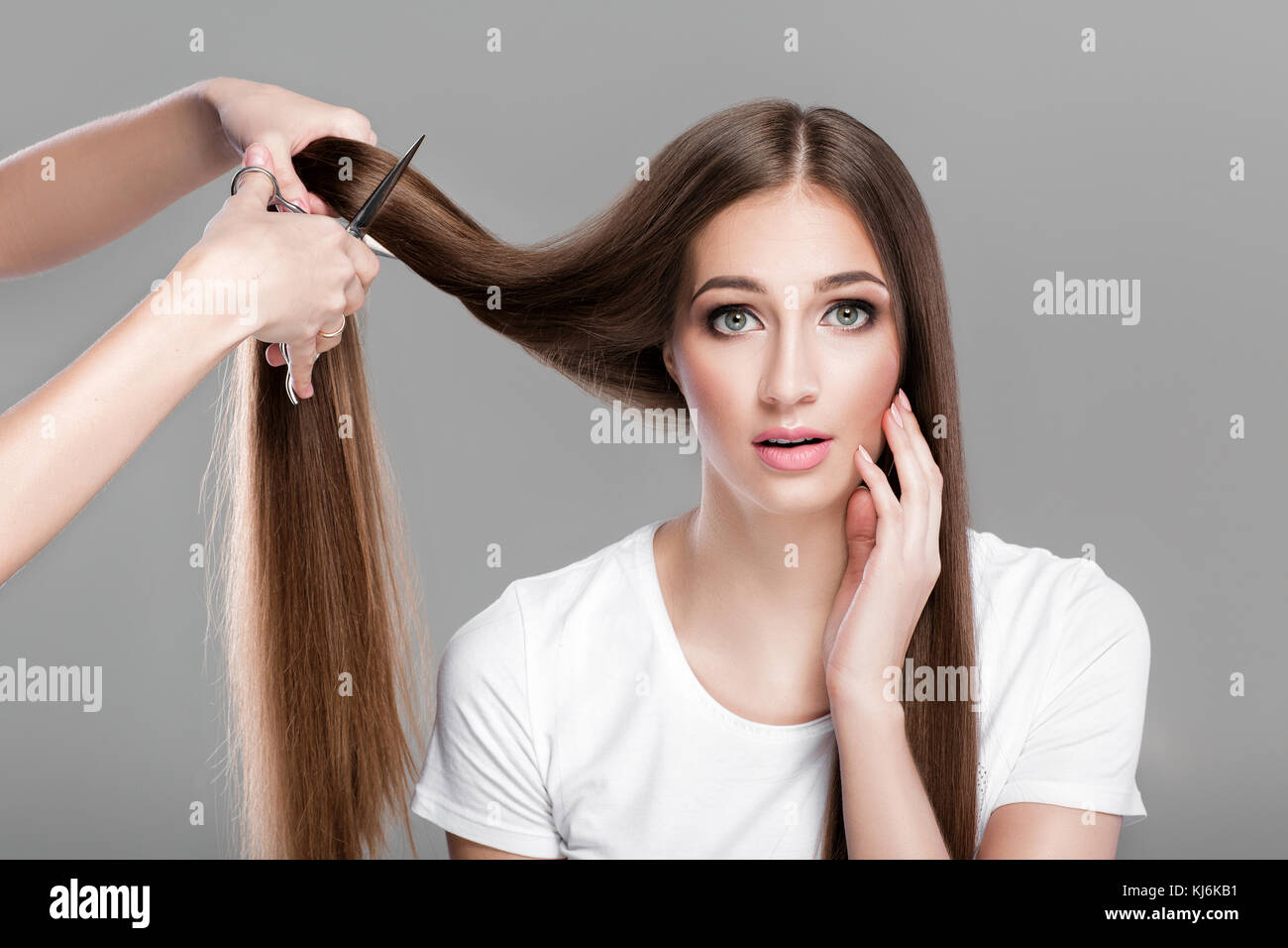 woman with  long hair holds scissors  Stock Photo