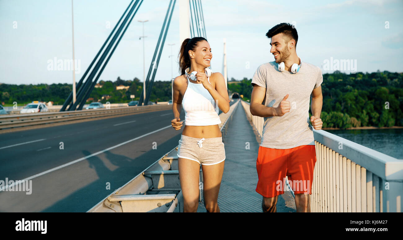 Athletic couple jogging in nature Stock Photo - Alamy