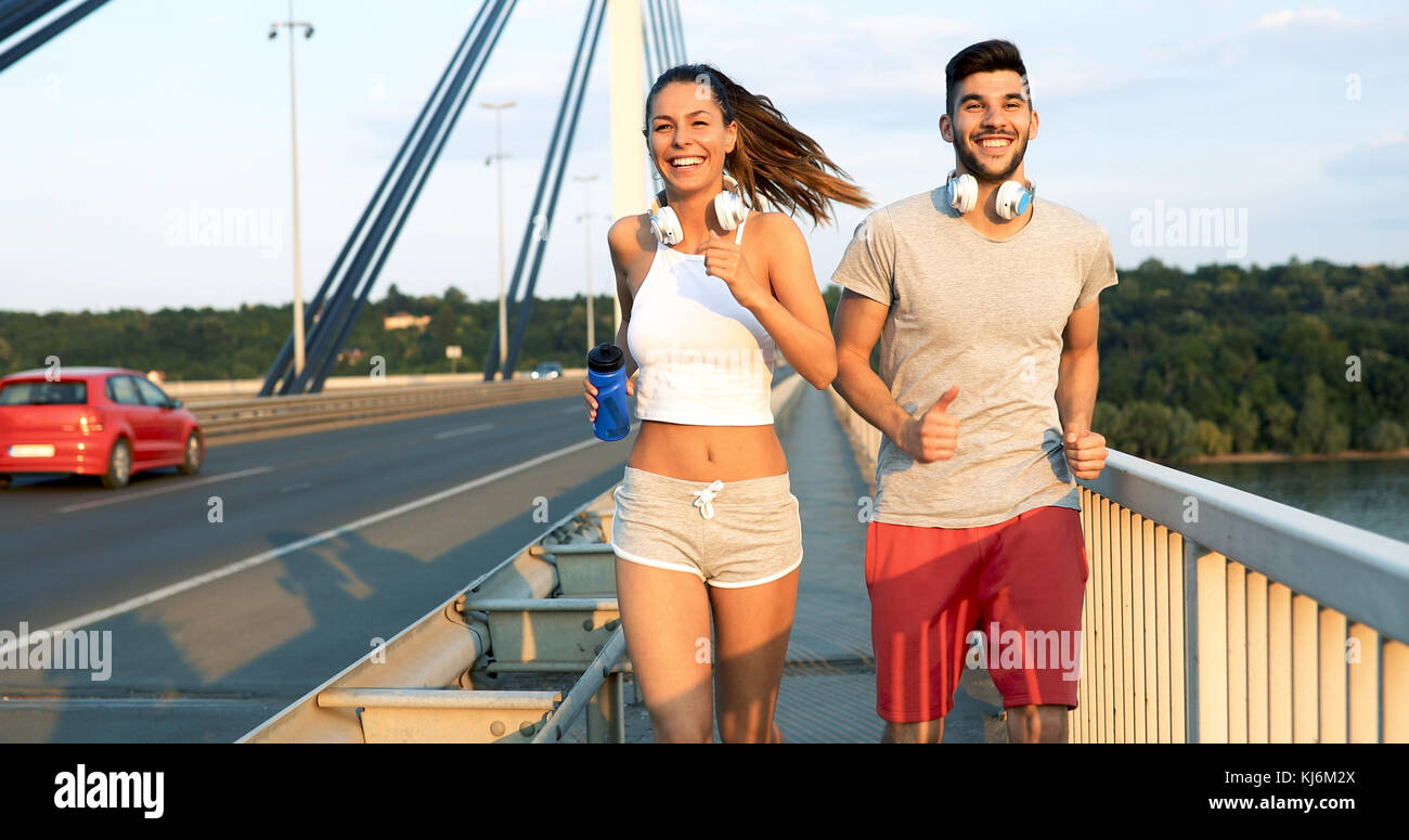 Athletic couple jogging in nature Stock Photo - Alamy