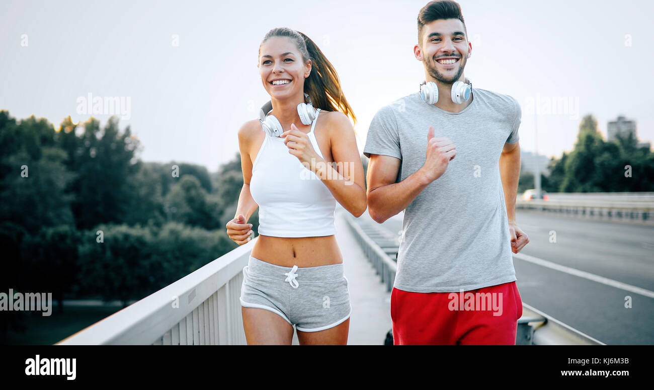 Attractive man and beautiful woman jogging together Stock Photo