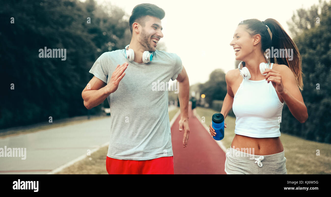 Athletic couple jogging in nature Stock Photo - Alamy