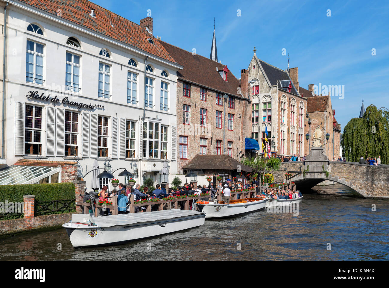 Boat tours on the Djiver Canal outside the Hotel de Orangerie, Bruges (Brugge), Belgium. Stock Photo