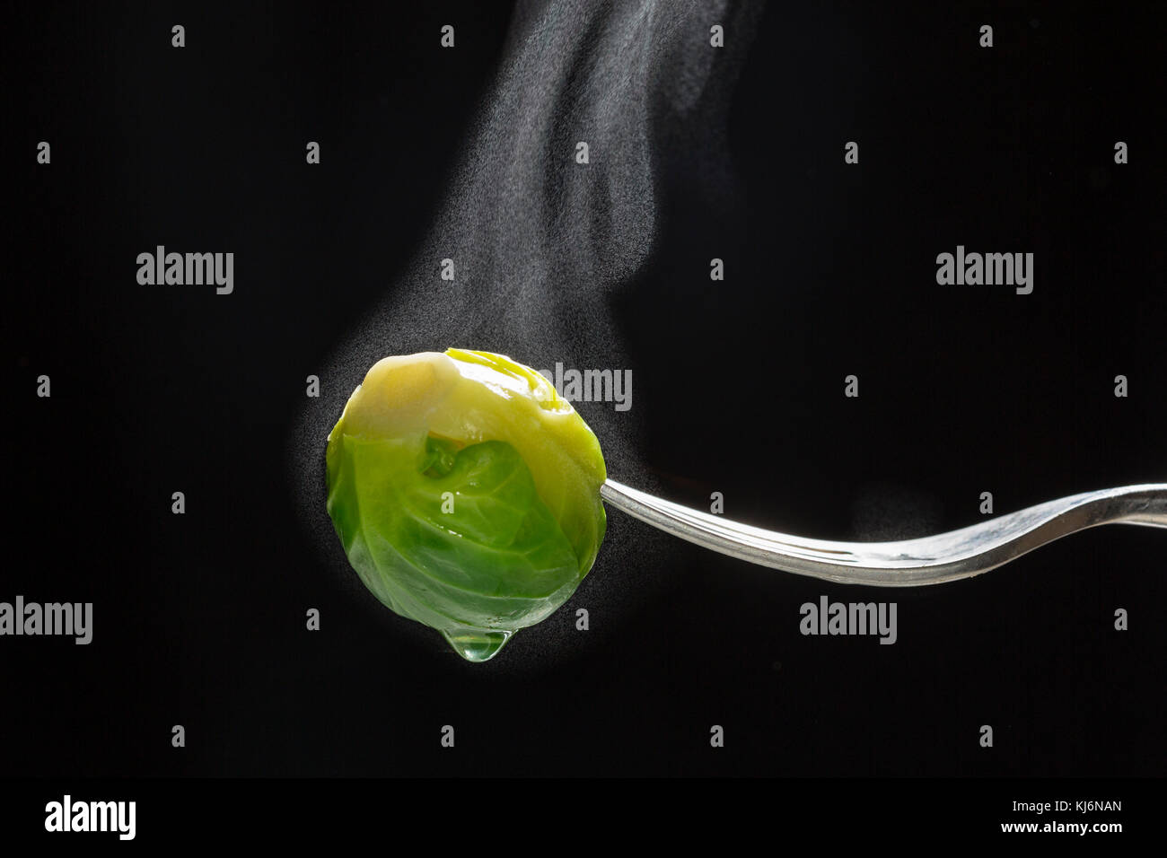 Steaming, just cooked, Brussels sprout on a fork. Stock Photo