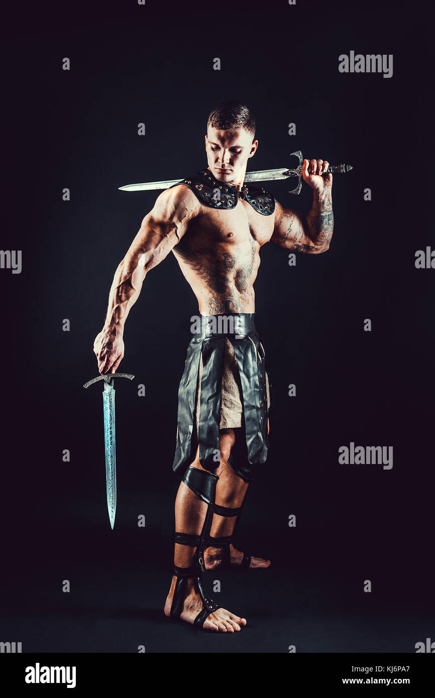 Severe barbarian in leather costume with sword Stock Photo