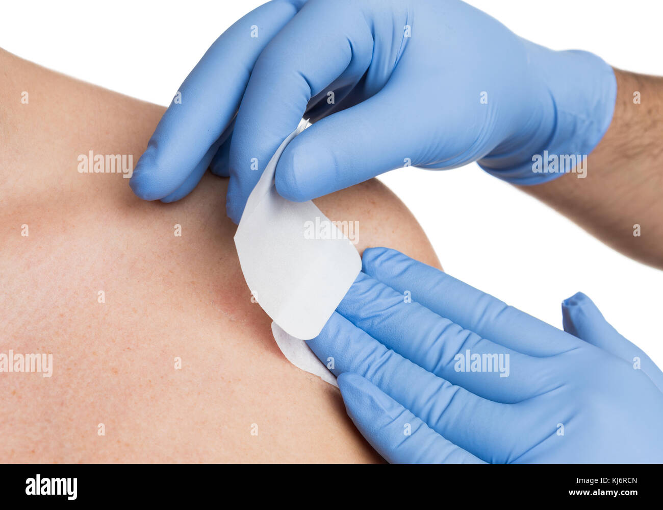 Nurse hand patching mole removal surgery incision as epidermal birthmark concept Stock Photo