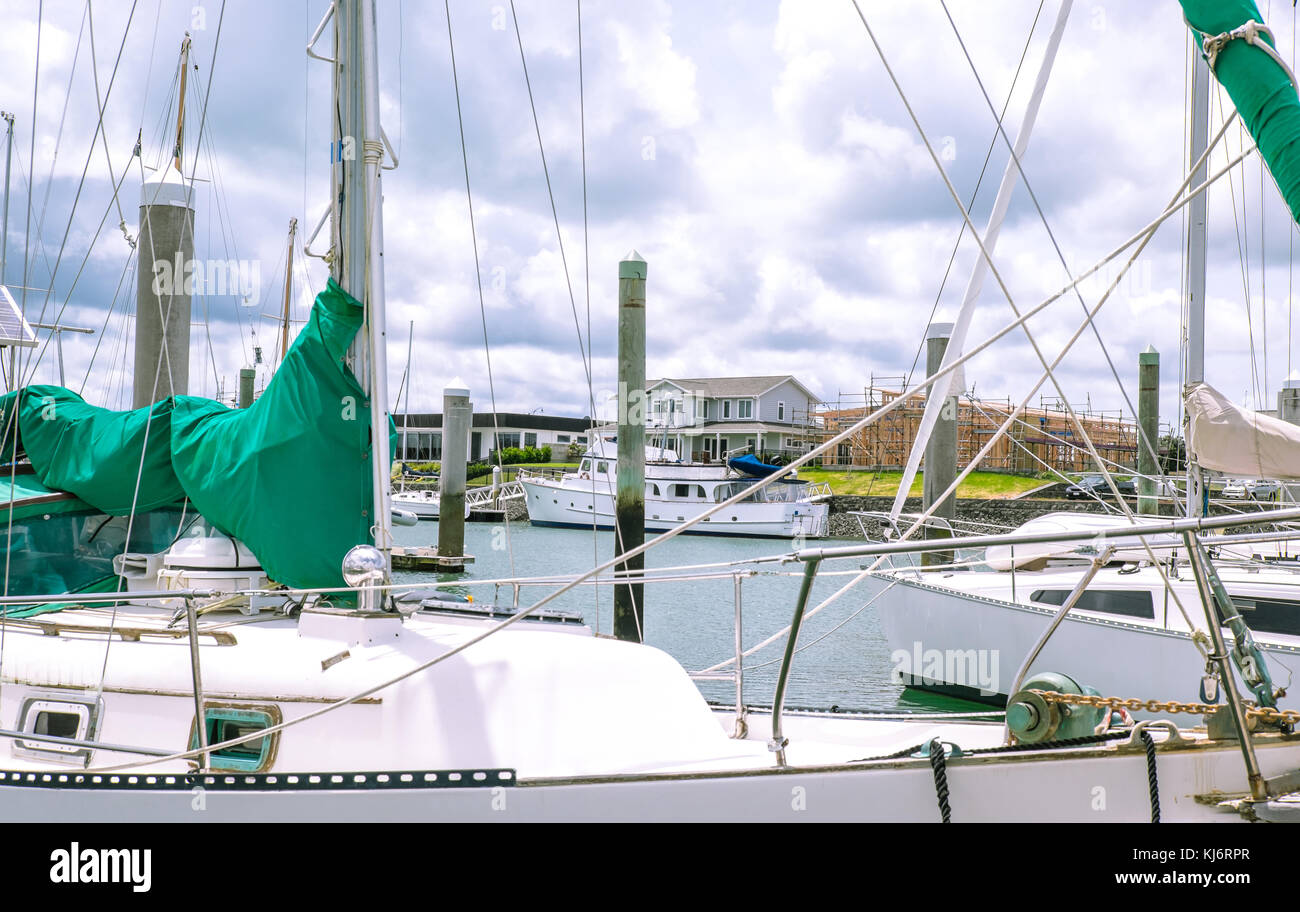 Looking through sailboat yacht masts and rigging to new house