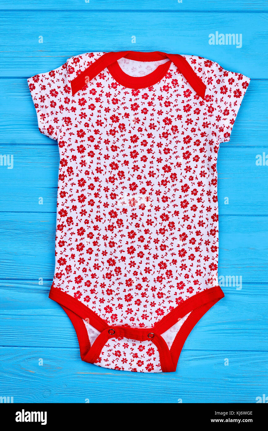 Newborn girl organic lovely bodysuit. Top view of cute cotton jumpsuit