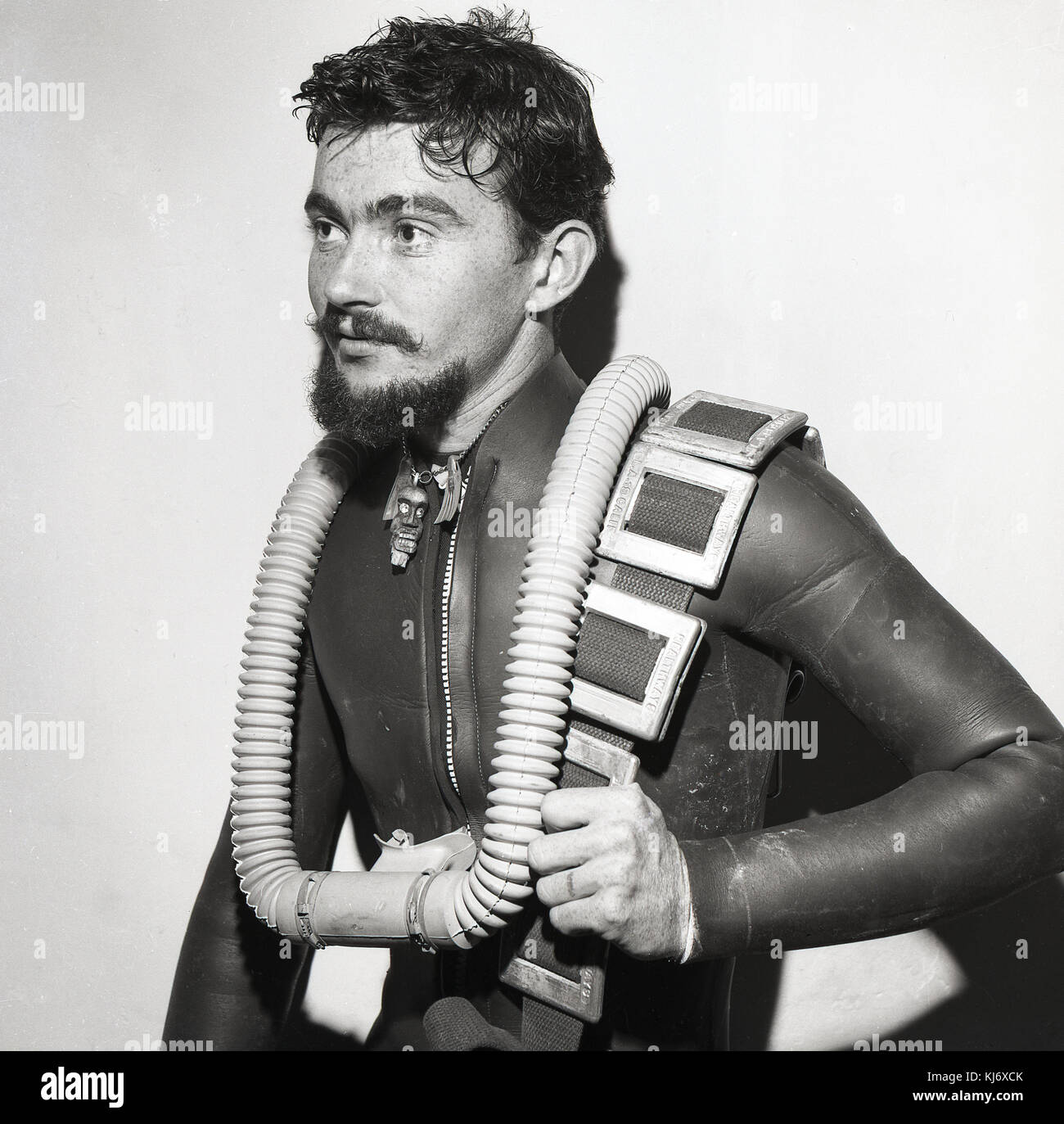 1960s, historical, picture shows a young male scuba diver in a wetsuit