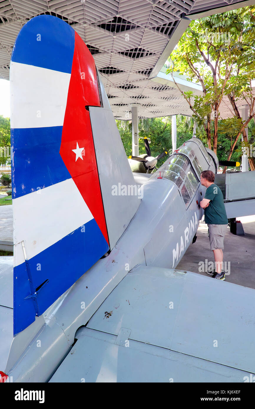 Tourist looking af a captured Vought OS2U-3 Kingfisher Plane, Museo de la Revolución Museum, Havana, Cuba Stock Photo