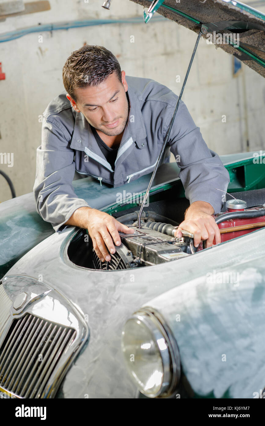 Young mechanic repairing an old car engine Stock Photo Alamy