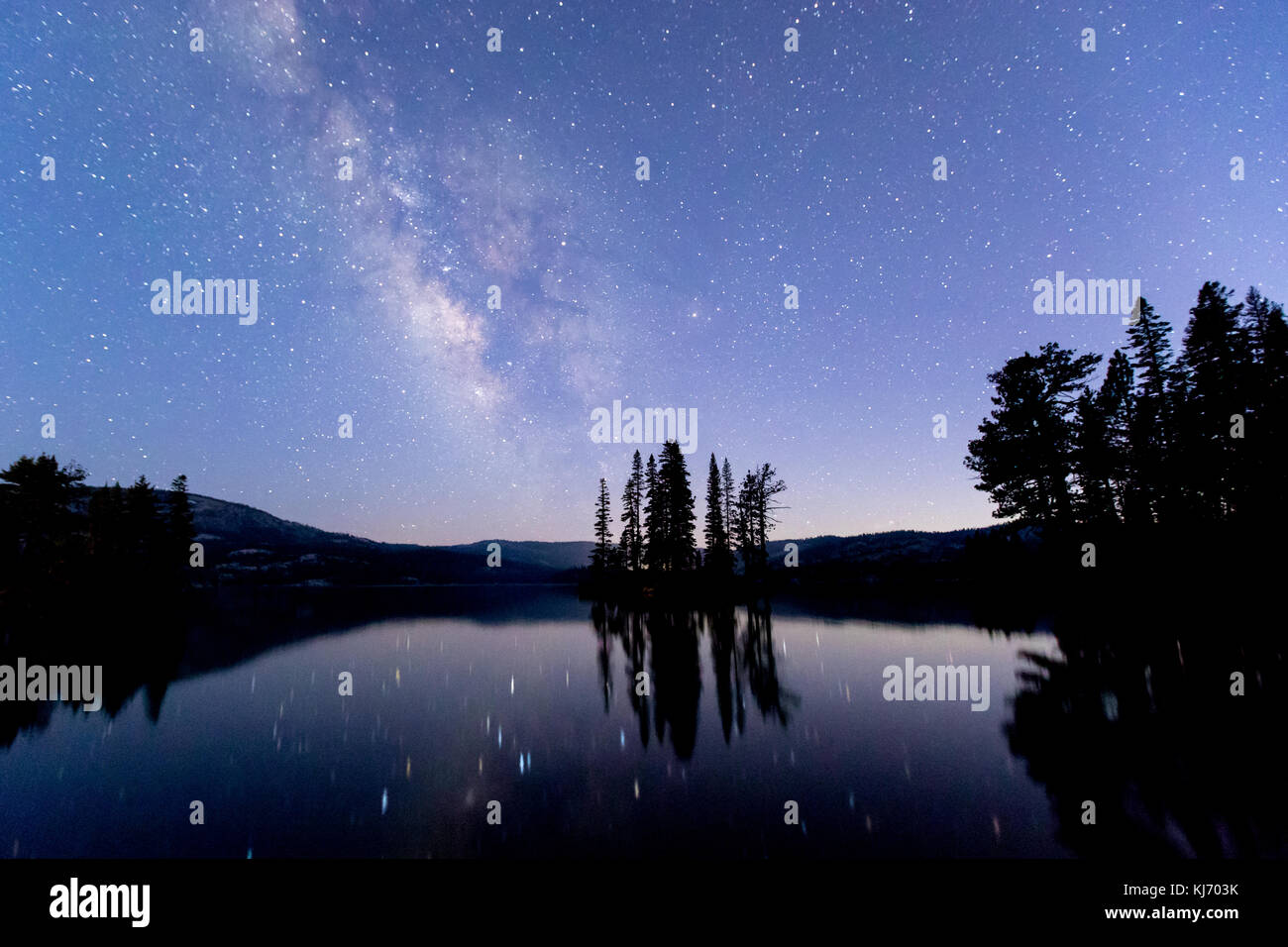 The Milky Way and stars reflected in Silver Lake in Amador County, California Stock Photo