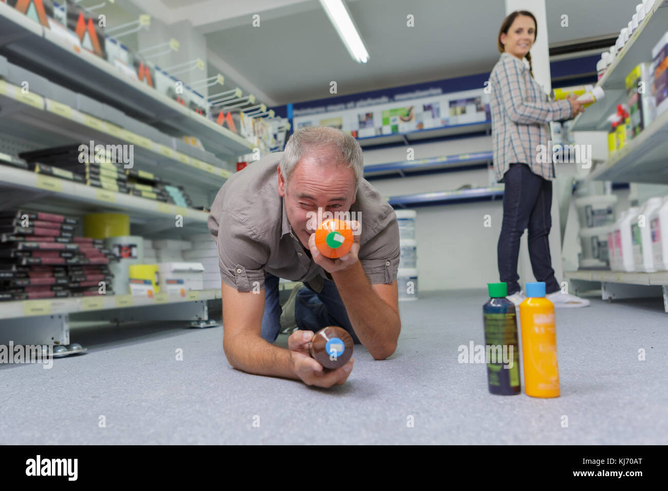 middle-age man choosing household chemicals in supermarket Stock Photo